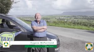 Eugene McPartland in front of his taxi with Benbulben in background